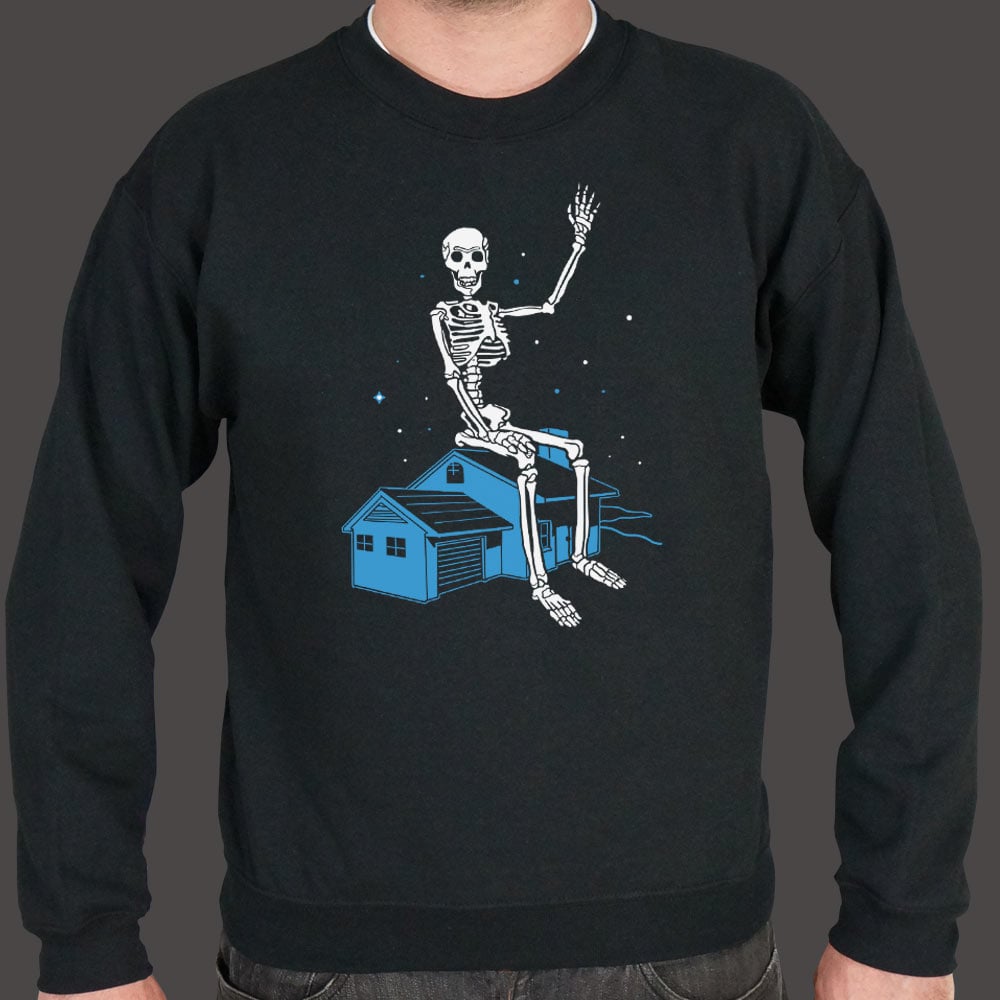 Giant Skeleton Waving from Rooftop of a House